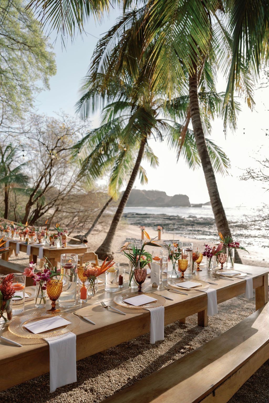 Beach wedding set with gold relief chargers, amber and purple glassware