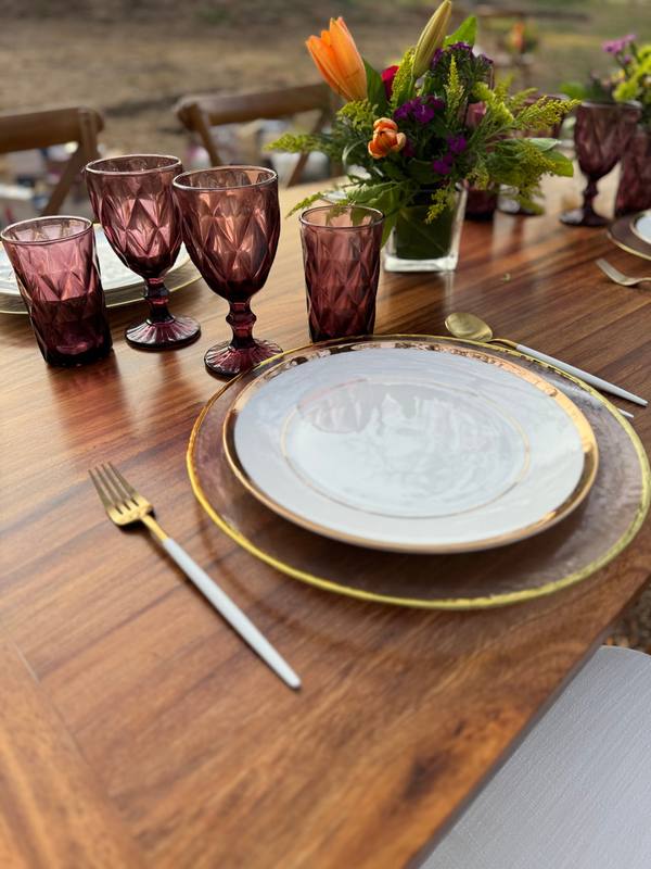 Golden glass charger: Styled with a gold rim plate and purple glassware