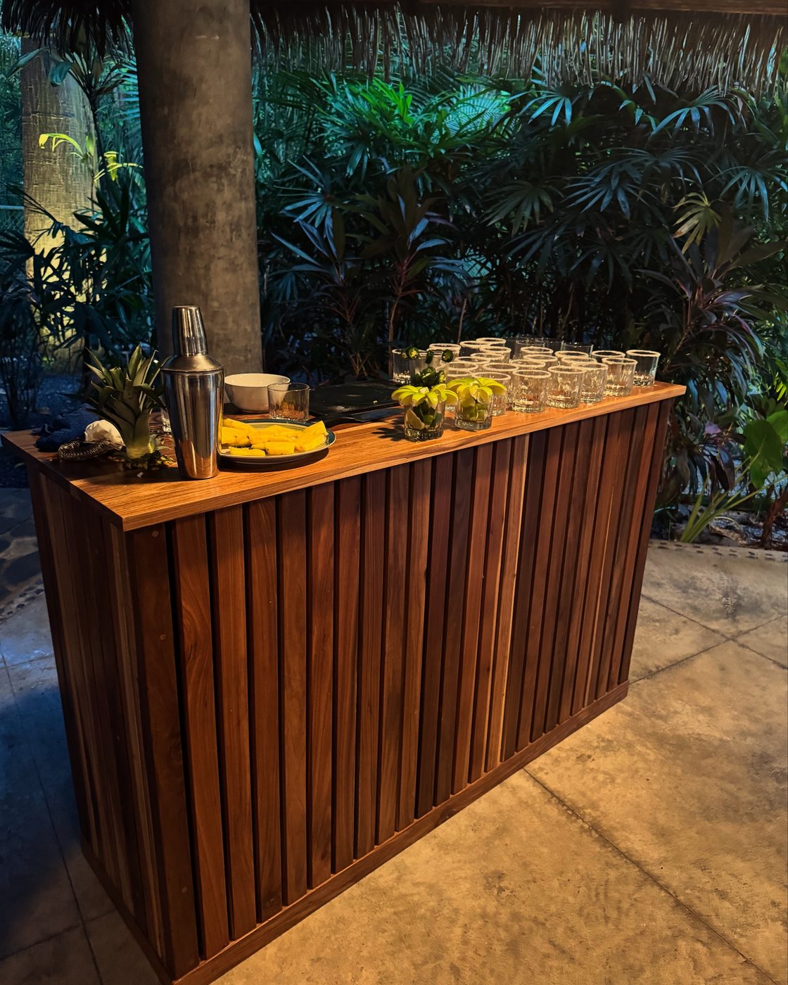 Laurel bar: Set up with cocktail glasses and fresh fruit under a palapa at a private villa